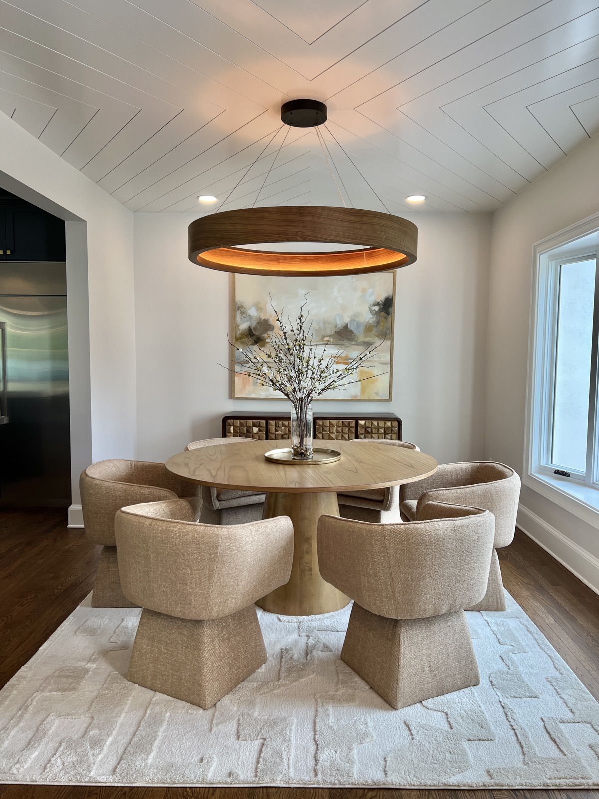 Modern dining room with a sculptural table, styled for a high-end home