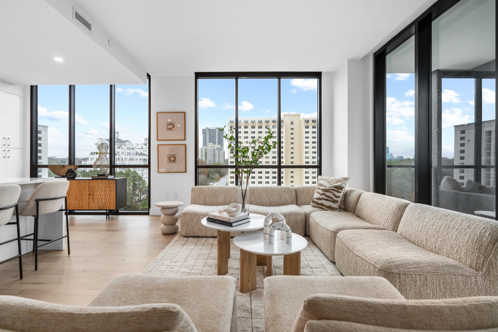 High-rise living room with skyline views, staged by Design2Sell